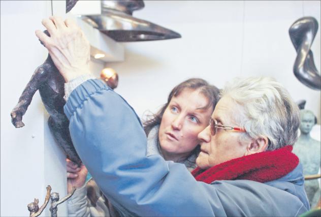 Taub und blind: Die Funktion von Augen und Ohren müssen bei Taubblinden die Hände übernehmen. Eine Frau (rechts) ertastet eine hölzerne Christusfigur. Foto: Taubblindendienst 