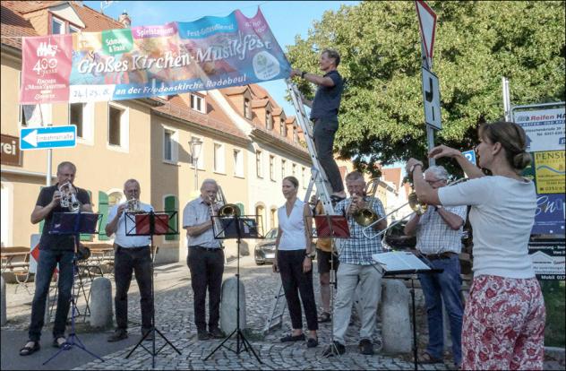 Zu den Klängen des Posaunenchors entfaltete Ingolf Miersch am Montag das große Banner auf dem Anger in Radebeul-Kötzschenbroda. © Birgit Andert Zu den Klängen des Posaunenchors entfaltete Ingolf Miersch am Montag das große Banner auf dem Anger in Radebeul-Kötzschenbroda. © Birgit Andert